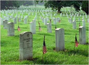 Arlington Memorial Cemetery of grave sites draped with American flags.